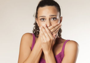 woman covering her mouth with her hands